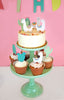 llama cupcake toppers on a white cake and cupcakes
